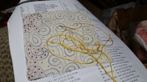I started with red French knots and saw the pattern; ready to continue with yellow "L's" on the next row