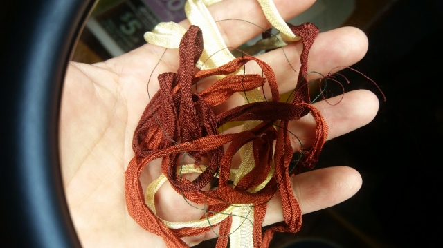 This is what the ribbons looked like *after* I distressed them with water and *before* I wove them ever so tightly into that third bracelet on the right.