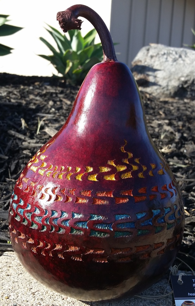 She "chip carved" the outside of this gourd (involves a special tool that makes a notch or chip, then you scoop toward the notch). Then she dyed the notches.